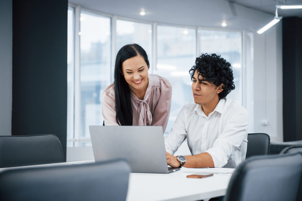 a lady and gentleman talking in an office setting