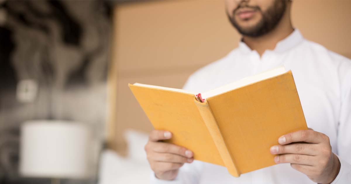 a gentleman holding a book