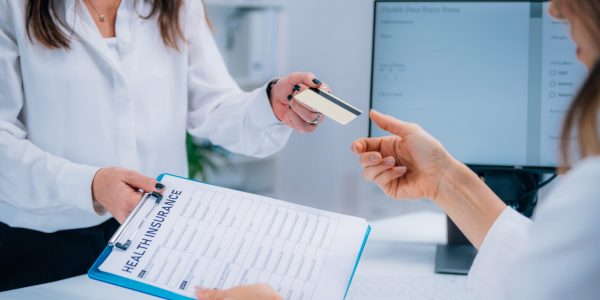 Woman Paying Health Insurance with Credit Card