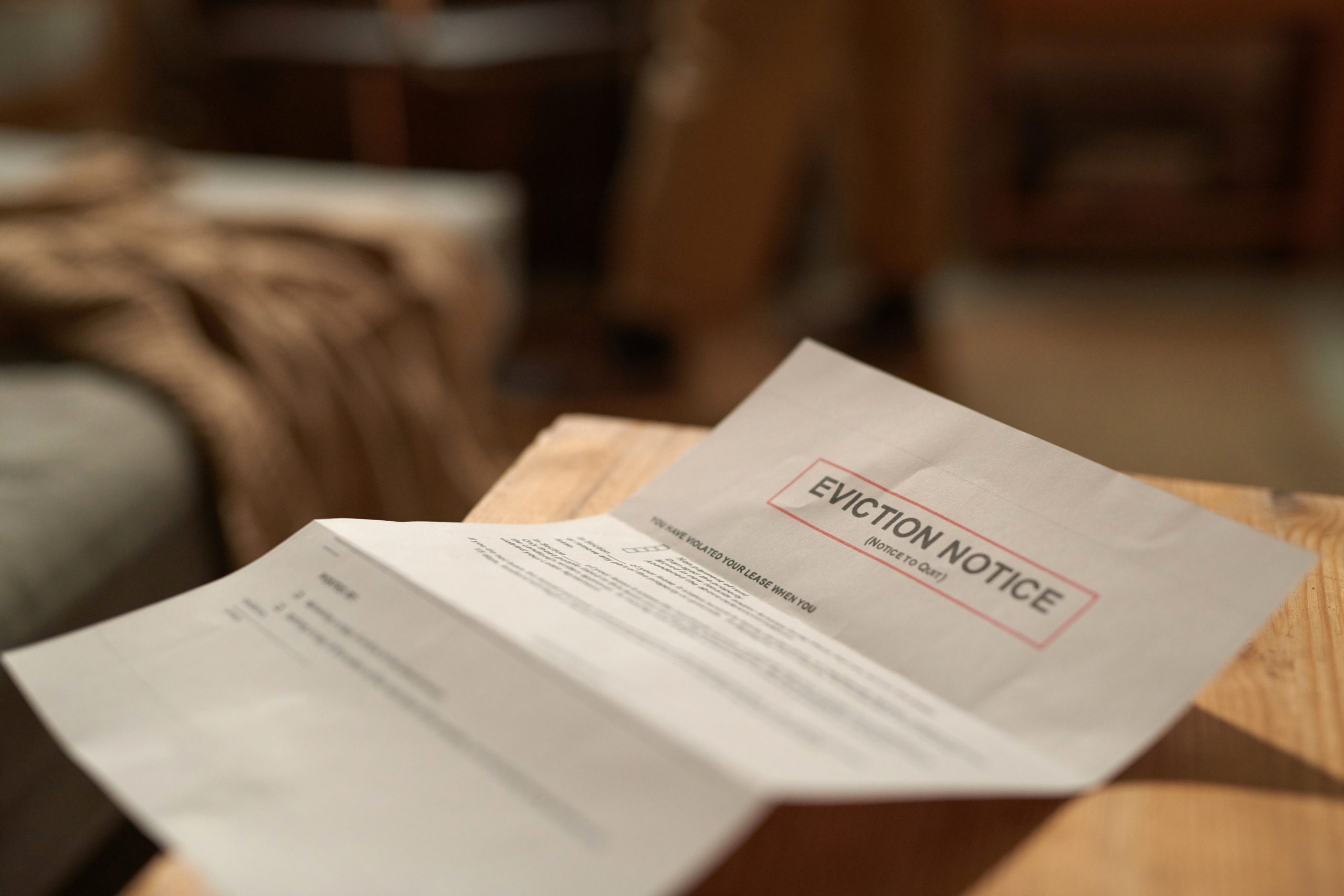 Room Eviction Notice Placed On Wooden Desk